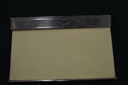 An Asprey & Garrard silver post-it note holder.