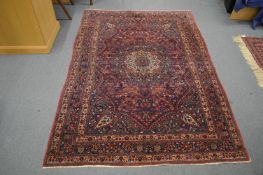 A good Persian rug with floral decoration, 202cm x 139cm.