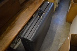 A folding upholstered massage table (?).