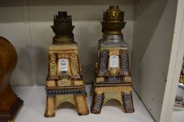 A pair of Eiffel tower pottery oil lamps.