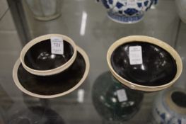 A Chinese pottery tea bowl and stand together with a similar bowl, both with dark brown slip