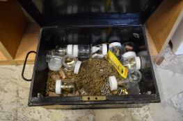 A small tin trunk containing picture hanging equipment.