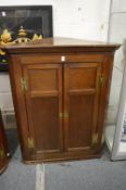 An oak hanging corner cupboard.