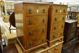 A pair of walnut four drawer pedestal chests.