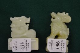 Two Chinese carved jadeite models of lions.