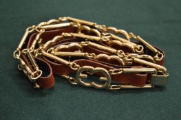 An Italian made gilt metal and leather belt.