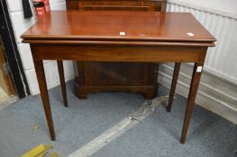 A mahogany rectangular fold-over tea table.