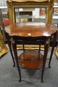 An Edwardian mahogany shaped top two-tier occasional table.