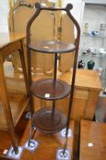 A mahogany folding cake stand.