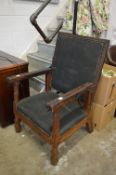 An old fruit wood armchair with reclining back.