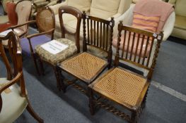 A pair of cane seated dining chairs and two other chairs.