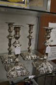 A matched set of four silver candlesticks, filled bases.