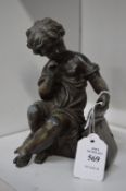 A cast spelter group of a young child with a book.