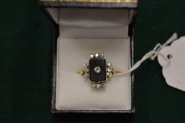 A good gold, diamond and onyx set ring.