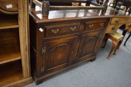 A small oak reproduction sideboard or dresser base.