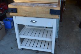 A butchers block on painted stand with single drawer and storage racks.