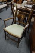 An Edwardian inlaid mahogany occasional armchair.