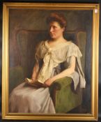 Kenneth Edwin Wootton (1885-1974), a portrait of a seated lady holding a book, oil on canvas, signed