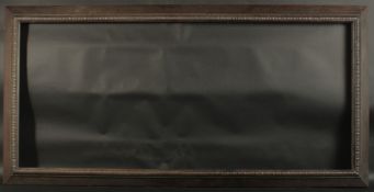 A BLACK CARVED TOP PICTURE FRAME. Rebate size 24ins x 54ins. 3.