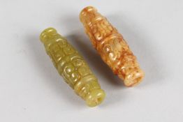 TWO CARVED JADE BEADS. 2.5ins long.