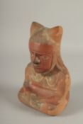 A SOUTH AMERICAN POTTERY VESSEL, modelled as a seated figure (faults). 22cms high.