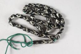 AN ISLAMIC SILVERED BEAD NECKLACE. 24ins long.