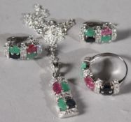 A SILVER EMERALD, RUBY AND SAPPHIRE RING, PENDANT AND EARRINGS SET.