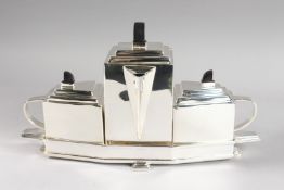 A CHRISTOPHER DRESSER DESIGN DECO THREE-PIECE TEA SET on stand.