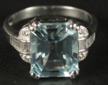 AN 18CT WHITE GOLD AQUAMARINE AND DIAMOND RING. Emerald cut aquamarine 3.41ct. RBC and baguette