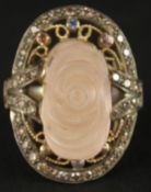 A LARGE AND IMPRESSIVE SILVER GILT RING set with a large carved rose quartz and coloured diamonds,