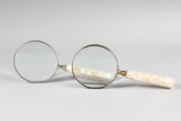 A PAIR OF MAGNIFYING GLASSES with mother-of-pearl handles.