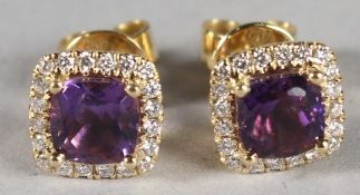 A PAIR OF 18CT YELLOW GOLD, AMETHYST AND DIAMOND STUD EARRINGS.