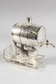 A SILVER PLATE WHISKY BARREL on a bear and sleigh.