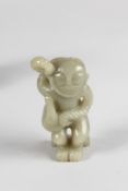 A SMALL CARVED JADE FIGURE. 3.5ins high.