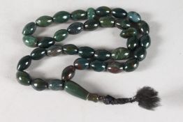 AN AGATE JADE NECKLACE with tassel. 24ins long.