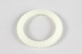 A CHINESE CARVED WHITE JADE TWIST BANGLE. 3ins diameter.