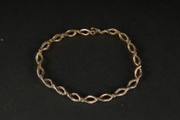 A GOLD-PLATED SILVER TWIST STYLE BRACELET set with diamonds (0.50ct approx.), boxed.