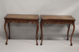 A GOOD PAIR OF IRISH MAHOGANY FOLDING TOP CARD TABLES, with plain top and leather interior