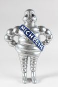 A CAST MICHELIN MAN, wall mounted. 13ins high.