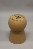 A CORK AND METAL CHAMPAGNE STOOL.