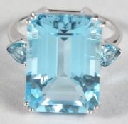 A SILVER LARGE BLUE TOPAZ RING.