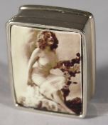 A SILVER NUDE ENAMEL PILL BOX.