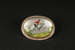 A 14CT ROSE GOLD BAR PIN BROOCH set with a rare Essex crystal depicting a jockey on horseback