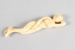 A CARVED BONE NUDE DOCTOR'S FIGURE. 5ins long.