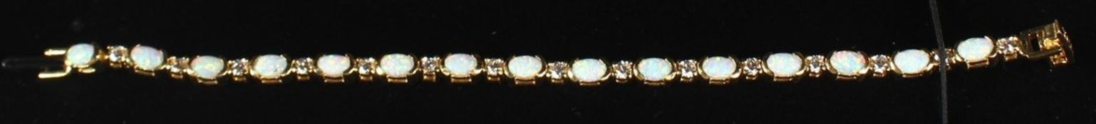 A SILVER 18CT GOLD PLATED OPAL LINE BRACELET.