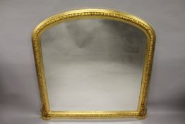 A GILTWOOD SHAPED TOP OVERMANTLE MIRROR. 4ft 7ins high x 4ft 5ins wide.