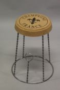 A CORK AND METAL CHAMPAGNE STOOL.
