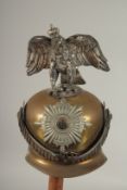 A LARGE PRUSSIAN BRASS AND LEATHER GARDE DE CORPS HELMET, with a large eagle badge MIT. GOTT. FUR.