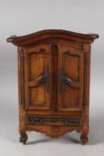 A 19TH CENTURY FRENCH APPRENTICE OAK ARMOIRE with serpentine top, double panel doors, long drawers