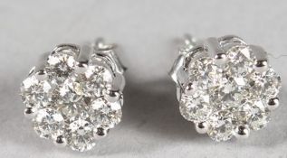 A PAIR OF 18CT WHITE GOLD SEVEN-STONE DIAMOND CLUSTER EAR STUDS.